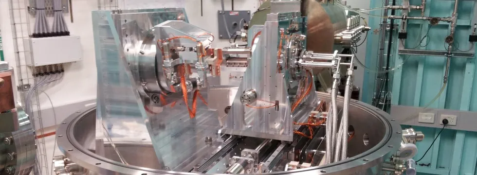 Double Laue-crystal monochromator mechanics inside the open vacuum vessel